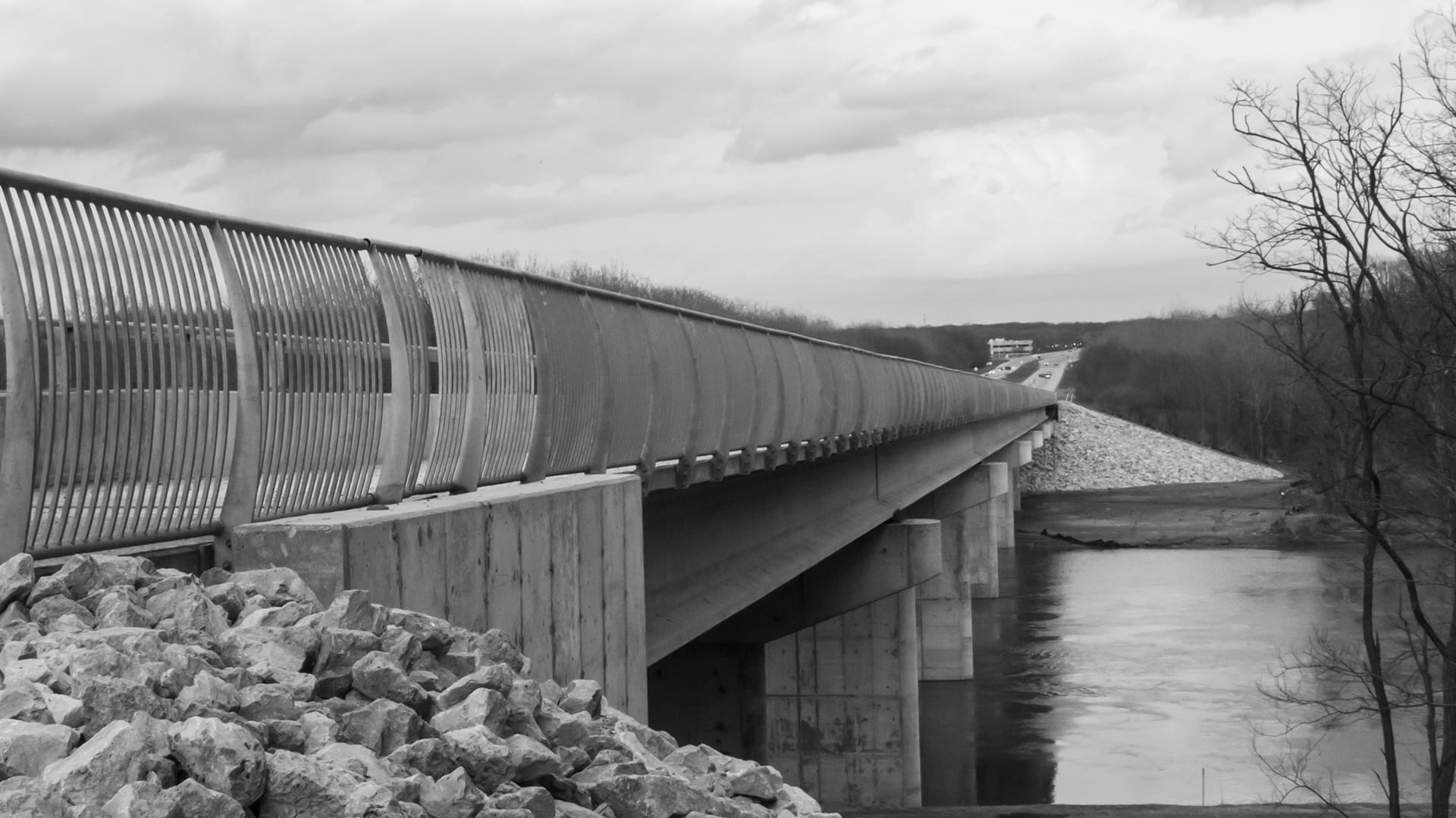 Decorative bridge handrail system spanning a river — James H Drew Corporation ornamental steel bridge rail project
